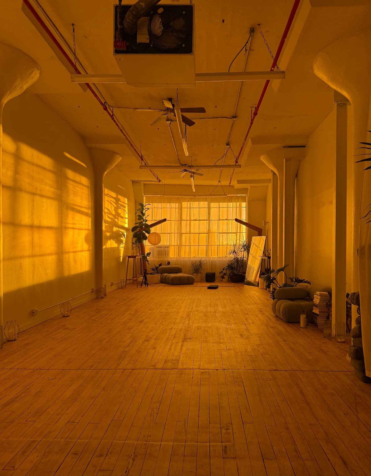 Late afternoon sun filling the Soul Therapy studio, tall windows and a long wood floor