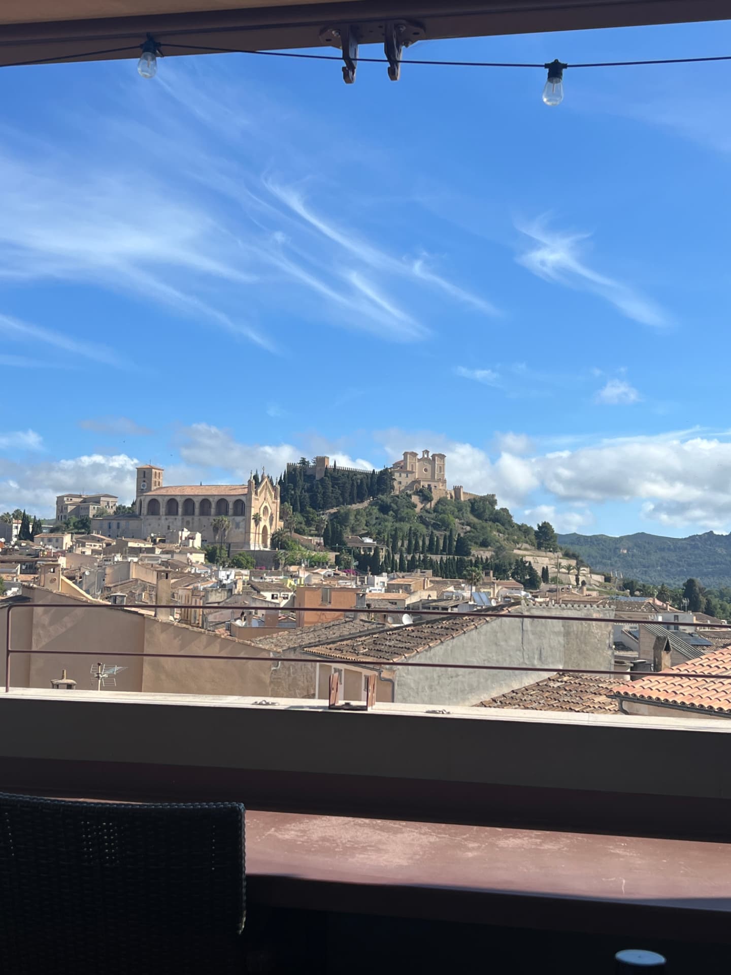 The hilltop church and sanctuary of Artà seen across terracotta rooftops