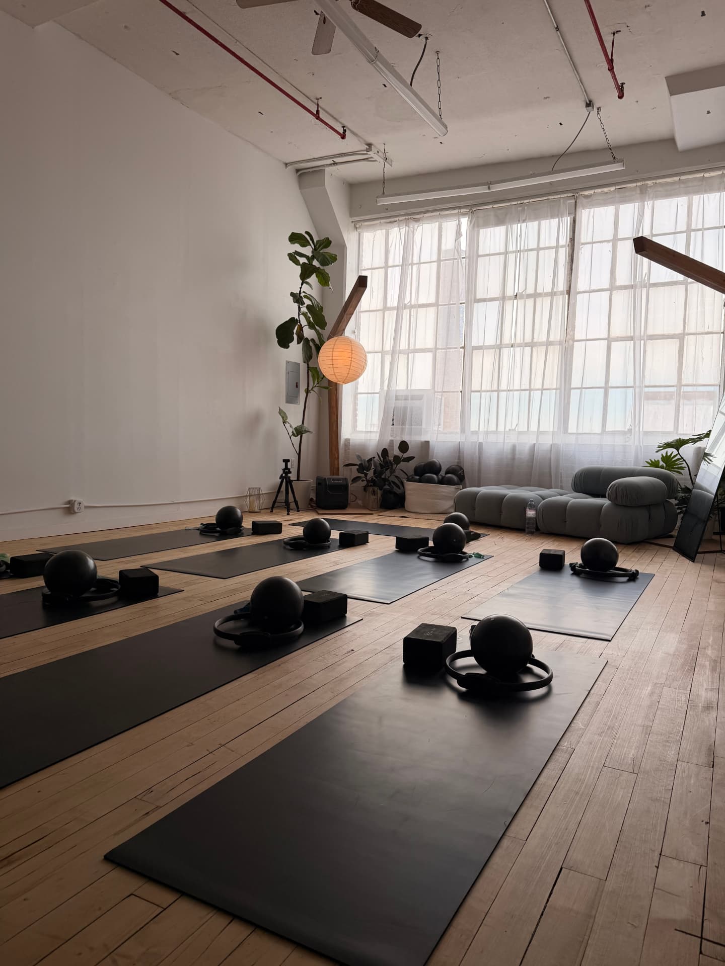 Mats, blocks, and weighted balls set out in rows before class